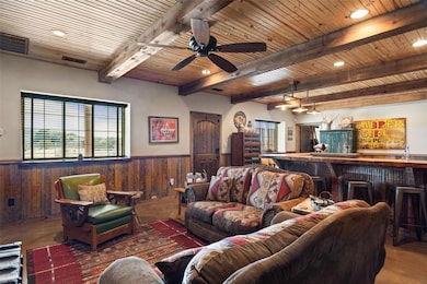 Living area with visible vents, wooden ceiling, an