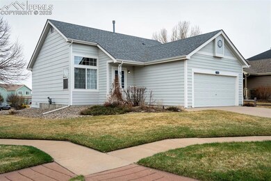Ranch-style house with a front lawn, driveway, a g