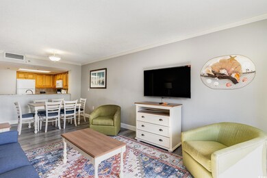Living area with ornamental molding, wood finished