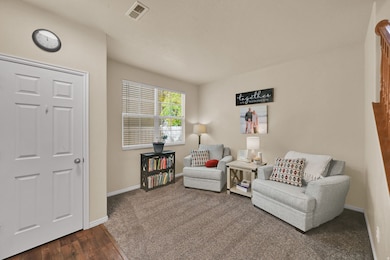 Living area featuring dark wood finished floors and baseboards