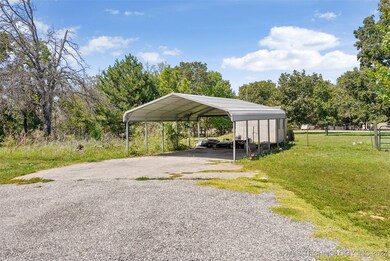 A 2 car covered garage is handy for auto storage.