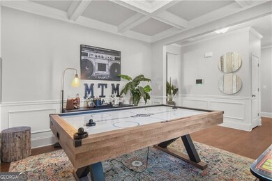 Game room with hardwood / wood-style flooring, beam ceiling, crown molding, and coffered ceiling