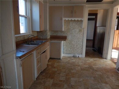 Kitchen with sink, light tile floors, and backsplash