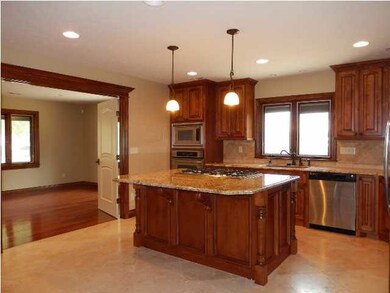 Open kitchen with granite and travertine.