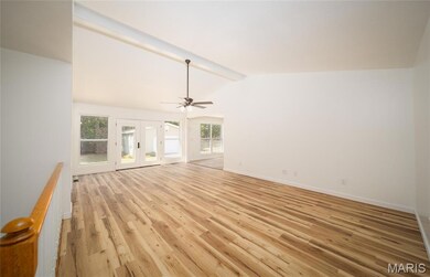 Unfurnished living room with french doors, healthy amount of natural light, light wood-style floors, and a ceiling fan