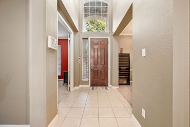 Entryway has high ceilings, sidelight, transom light; Office is photo left; Flexible Dining is photo right
