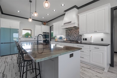 Island with amazonite countertop and copper sink.