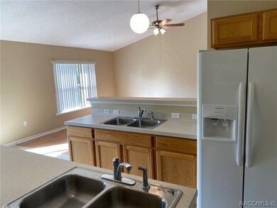 Kitchen with bar seating overlooking the family ro