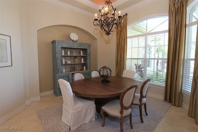 Dining room featuring ornamental molding, a chande