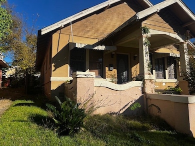 View of side of property with a patio area and stucco siding