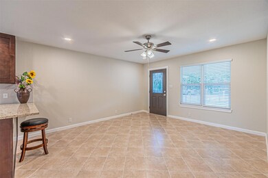 Tiled entrance foyer featuring ceiling fan