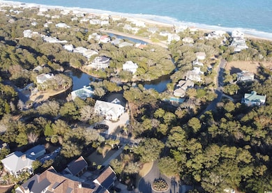 Aerial view featuring a water view and a view of the beach