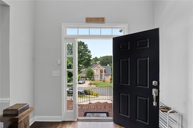 Entryway featuring wood finished floors and baseboards