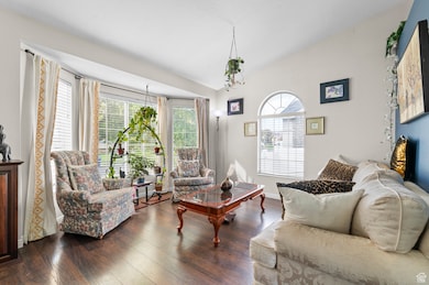 Living area featuring vaulted ceiling and wood finished floors