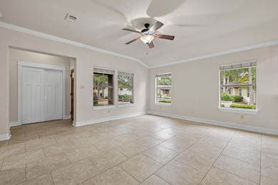 View of the living room without staging. It's a large open space with several options for furniture configuration. The foyer and double-door entry closet is there on the left of the photo.