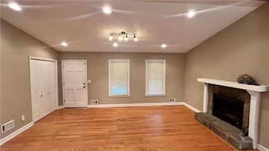 Unfurnished living room featuring a fireplace, light wood-style flooring, and recessed lighting