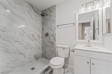 Bathroom featuring toilet, marble finish floor, a