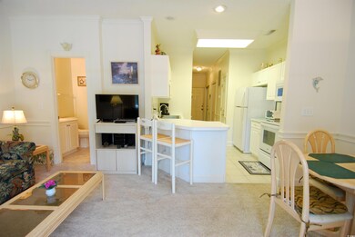 Living area with light colored carpet, crown moldi