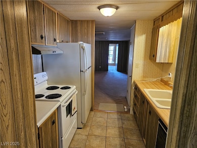 Kitchen featuring white electric stove, light coun