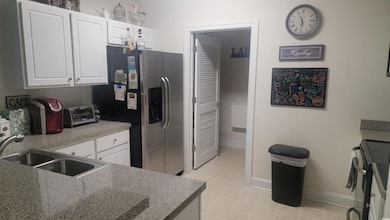 Kitchen featuring stainless steel refrigerator wit