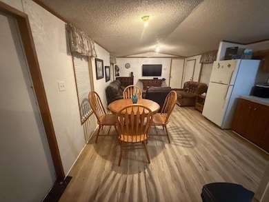 Dining space with lofted ceiling, a textured ceili