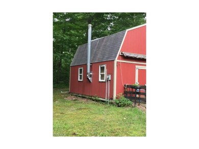 Side of cabin showing wood burner venting