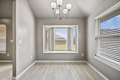 Empty room with a chandelier and lofted ceiling