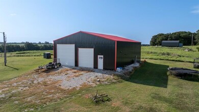 Garage with a rural view and a lawn