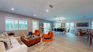 Living area featuring recessed lighting, light woo