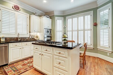 The kitchen island has a 5 burner gas Thermador co