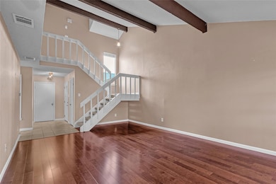 Entryway with wood finished floors, stairway, and
