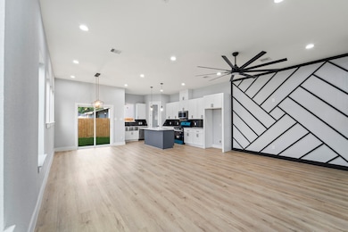 Open-concept layout flowing into the dining and kitchen