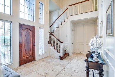 Stunning and spacious entryway welcomes guests with beautiful wall treatments and loads of natural light!