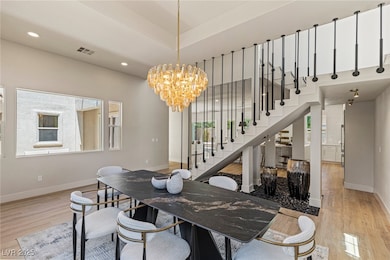 Dining area with a chandelier, wood finished floor