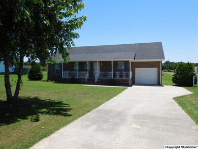 Oversized garage with work area and expanded driveway for easy movement of cars.