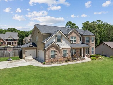View of front facade with driveway, brick siding, 