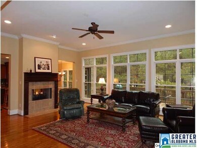 Lovely Den featuring see through Fireplace, Hardwo