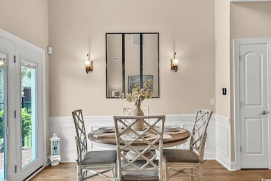 Dining space featuring wood finished floors, a dec