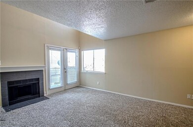 Unfurnished living room featuring a tiled fireplac