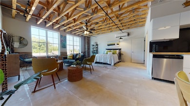Bedroom with concrete floors, a wall mounted air c