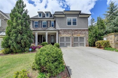 Craftsman house with a garage, brick siding, a fro