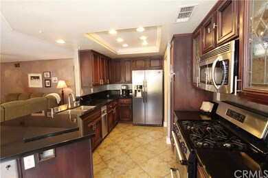 Remodeled Kitchen with granite countertops, stainless steel appliances and cherry cabinets.