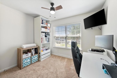 Bedroom being used as an office ceiling fan and a big window for natural light