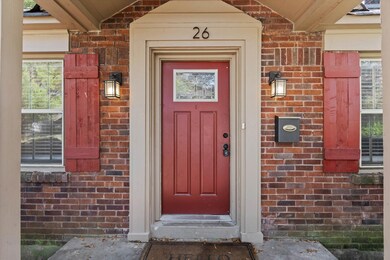 Doorway to property featuring brick siding