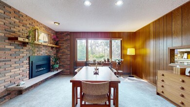 Dining or Main Floor Family Room with Gas Fireplace and Rear Facing (Garden VIew) Windows.