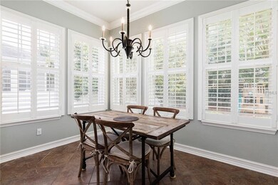 Breakfast nook with crown molding and plantation s