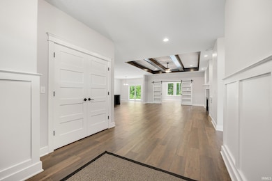 View of lg Great room with Beamed Ceiling, & view of Barn doors leading to Family Room.