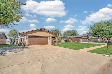 Ranch-style house featuring concrete driveway, brick siding, and a garage