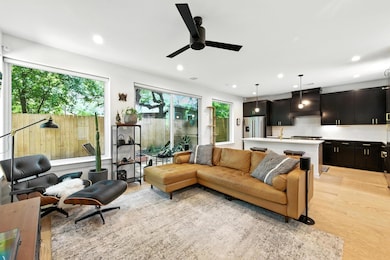 Living area featuring light wood-style floors, recessed lighting, and ceiling fan
