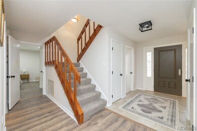 Entrance foyer with light hardwood / wood-style fl